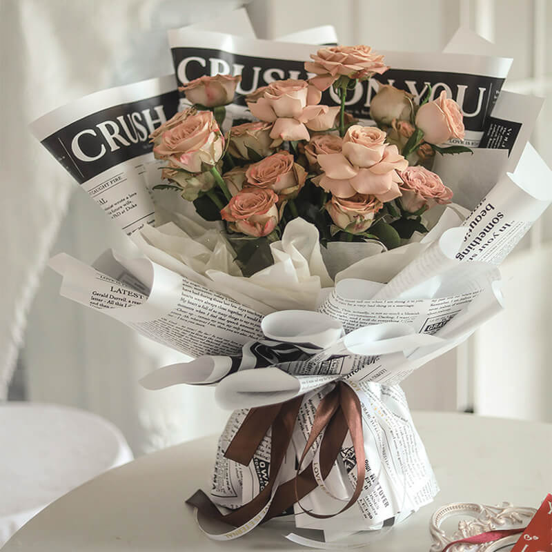 flowers wrapped in newspaper