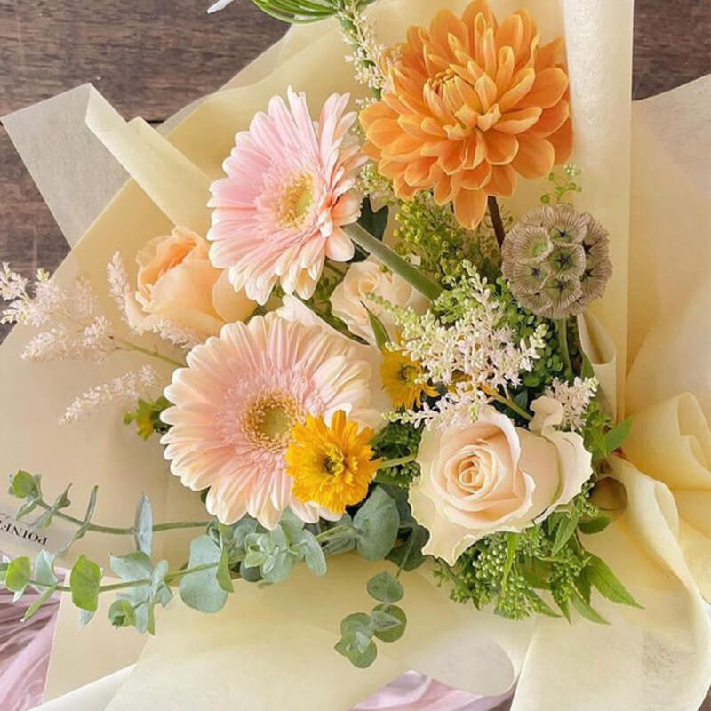 wrapping flowers in paper bag